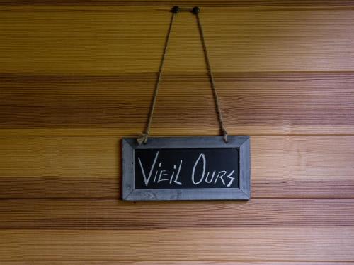 a sign that reads well ours hanging on a wooden wall at Superbe chalet-11 personnes-Chamonix(Les Bossons) in Chamonix-Mont-Blanc