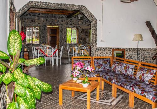 a living room with a couch and a table at Pousada Vila Paraíso in Santa Cruz