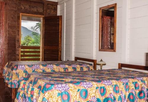 Un pat sau paturi într-o cameră la Pousada Vila Paraíso