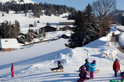 a group of people standing on a snow covered slope at Hotel Arvenbüel in Amden