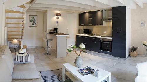 a kitchen and living room with a couch and a table at le clos de Tesson in Tesson