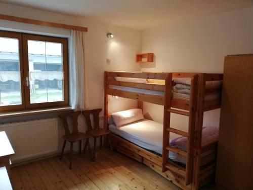 1 Schlafzimmer mit 2 Etagenbetten und einem Fenster in der Unterkunft Oberstockinghof in Saalfelden am Steinernen Meer