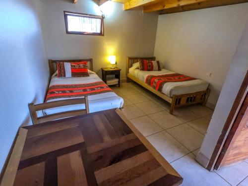 Ένα ή περισσότερα κρεβάτια σε δωμάτιο στο Hostal Nuevo Amanecer