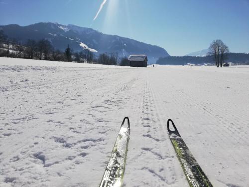 a pair of skis in a snow covered field at Oberstockinghof in Saalfelden am Steinernen Meer