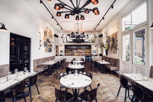 a restaurant with tables and chairs and windows at Morgan & Mees Amsterdam in Amsterdam