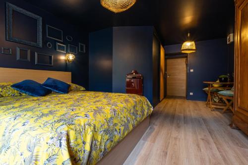 a bedroom with a bed and a wooden floor at Les Dames-Jeannes in Chavot-Courcourt