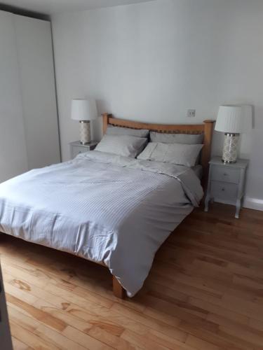 a bedroom with a large bed with two night stands at Luxurious Penthouse Apartment 1 , City Centre in Kilkenny