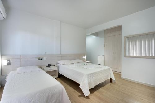 En eller flere senge i et værelse på Hotel Mirage