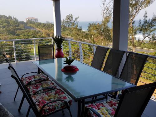 a table and chairs on a balcony with a view at Westbrook Cabanas 2nd in Westbrook
