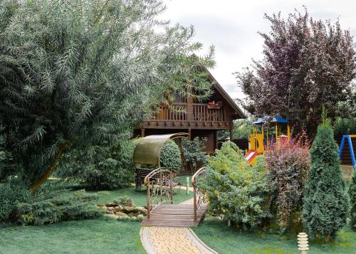 a wooden path leading to a house with a playground at Gorny Ruchej in Hora