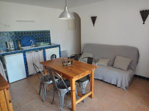 a living room with a wooden table and a couch at Villa Via serena in Ajaccio