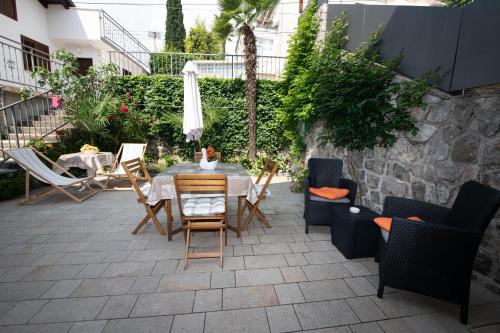 a patio with a table and chairs on a patio at Studio apartman Tasha in Opatija
