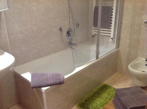 a bathroom with a shower and a tub and a sink at HOME DI CRISTINA in Laives