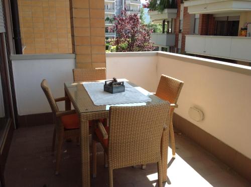 a table and chairs on a balcony with a box on it at HOME DI CRISTINA in Laives