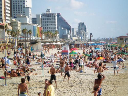 a large crowd of people on a beach at Comfortable quiet room with a private bathroom in shared apartment in Tel Aviv
