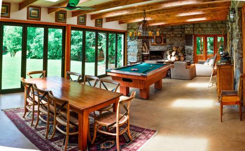 a living room with a table and a pool table at The FarSide Country Manor in Nottingham Road