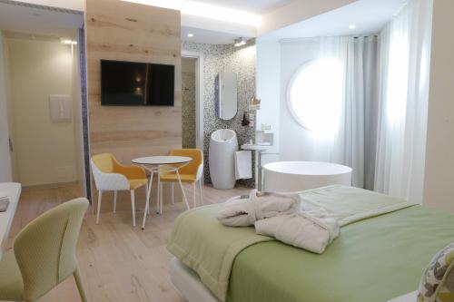a bedroom with a bed and a table and chairs at Astrea Wellness & Spa in Altavilla Silentina