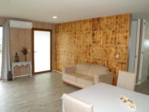 a living room with a couch and a table at Quintinha do Periqueiro in Castelo do Neiva