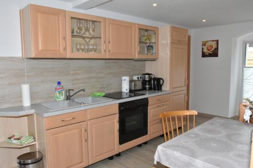 a kitchen with a sink and a stove top oven at König Ferienhaus in Königsbrück