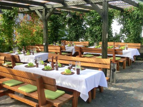 a group of tables with white table cloths on them at Landhotel Wieseneck in Winterfeld