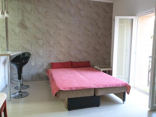 a bedroom with a pink bed with a pink blanket at Alex Apartments in Kruševo