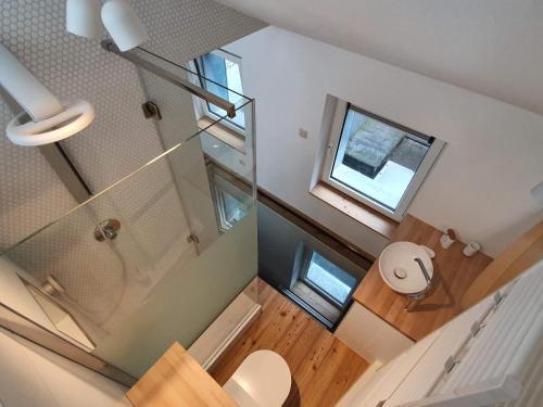 an overhead view of a bathroom with a toilet and a window at Bel appartement au cœur de Liège in Liège
