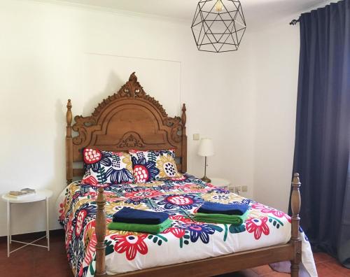 a bedroom with a large bed with a wooden headboard at Casa de Barreiros Studio AP in Barreiros