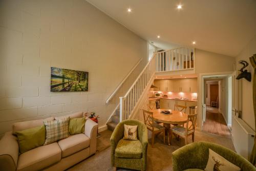 a living room with a couch and a table at Blairquhan Cottages in Maybole