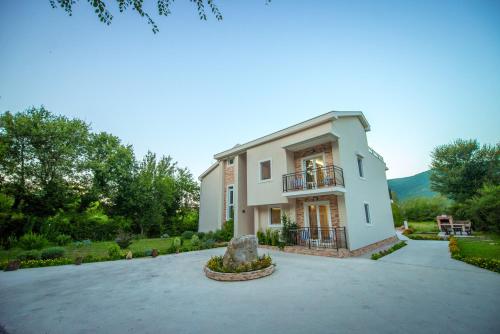 a large house with a large driveway at Apartment Vrutak in Kotor