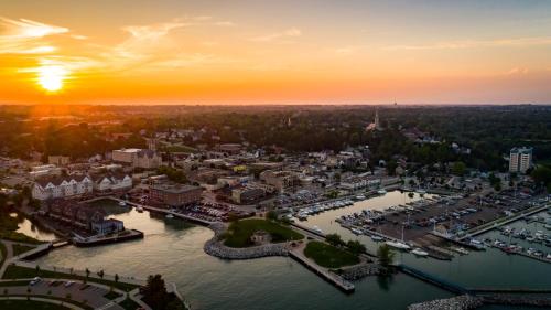 an aerial view of a marina at sunset at The Harborview on Lake Michigan, Ascend Hotel Collection in Port Washington