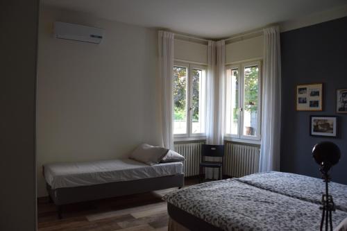 a bedroom with two beds and a window at GINEVRA'S COUNTRY HOME in Due Carrare