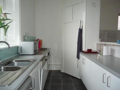 a kitchen with a sink and a microwave at Bishopton Apartment, near Glasgow in Bishopton