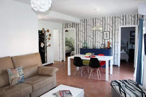 a living room with a couch and a table at Aloja Ayamonte in Ayamonte
