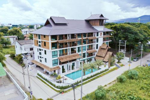 an aerial view of a building with a swimming pool at Pleasant Chiangmai in Chiang Mai