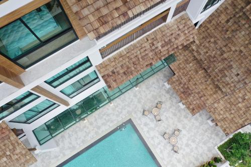 an overhead view of a swimming pool with chairs at Pleasant Chiangmai in Chiang Mai