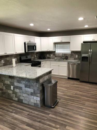 a kitchen with white cabinets and stainless steel appliances at Downtown Contemporary yet Cozy Fun in San Antonio