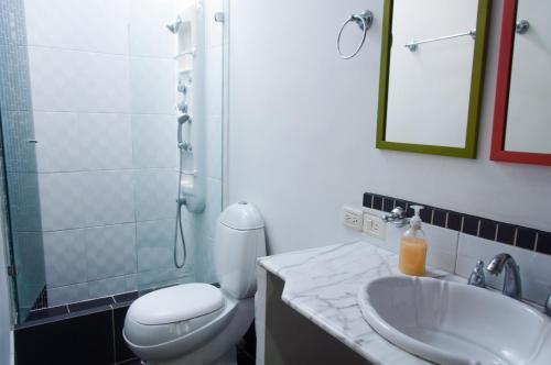 een badkamer met een toilet, een wastafel en een douche bij Apartamento 3 Cali Sur in Cali