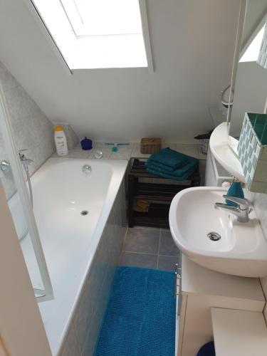 a bathroom with a sink and a tub and a toilet at Ferienloft im Grünen in Gschwend