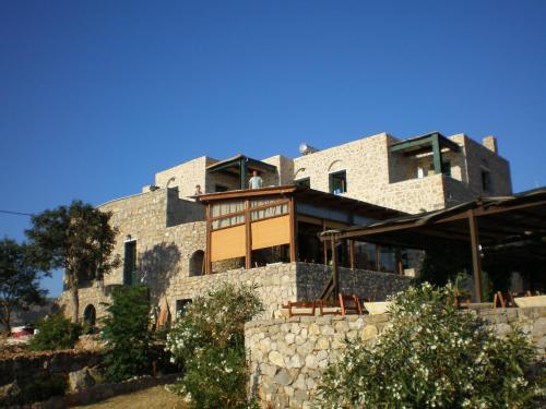 a man is standing on the balcony of a building at To Asteri in Avgonyma