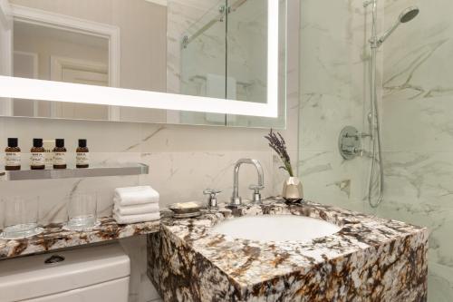 a bathroom with a sink and a shower at Fairmont Hotel Vancouver in Vancouver