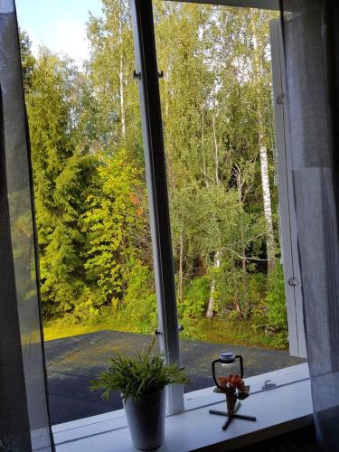 a window with a view of a road outside at Lovely, spacious apartment with free parking in Sandviken