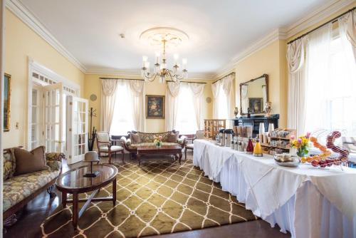 uma sala de estar com duas mesas e um sofá em Jared Coffin House em Nantucket