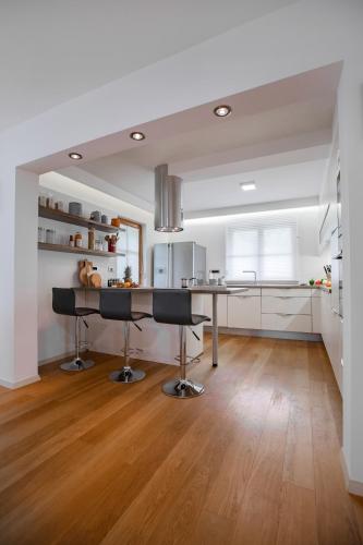 a kitchen with a table and two bar stools at House of Adventure - The Base to explore Slovenia in Laze v Tuhinju