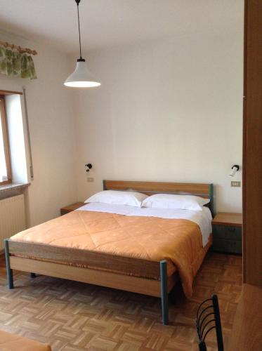 a bedroom with a large bed in a room at Verda Val in Campitello di Fassa