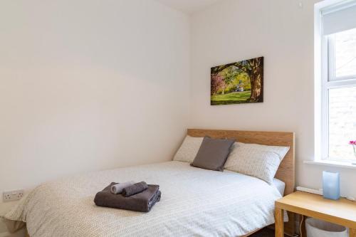 a bedroom with a bed with a pillow on it at SunnyBank in Denby Dale