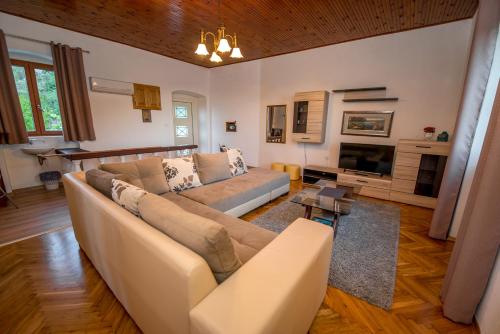 a living room with a couch and a table at Mediteraneo Villa in Kaluđerovići