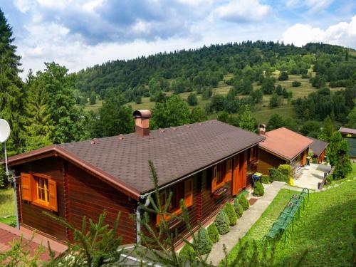 a house in the middle of a hill with trees at Drevenice Oščadnica in Oščadnica