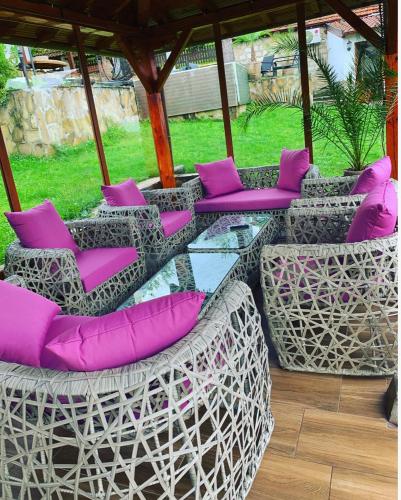 a group of chairs with purple pillows on a patio at Complex Ristanite in Elena