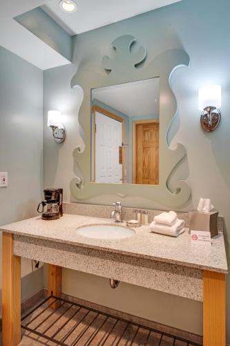 a bathroom with a sink and a mirror at 3 Peaks Resort & Beach Club in South Lake Tahoe