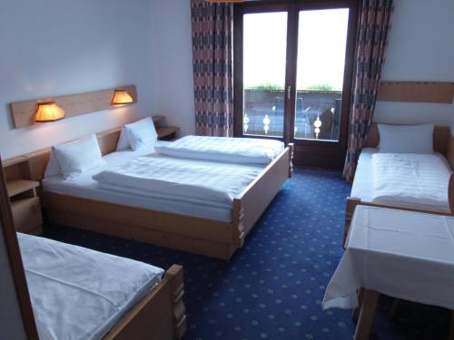 Cama ou camas em um quarto em Garni Runggner Traubenhof